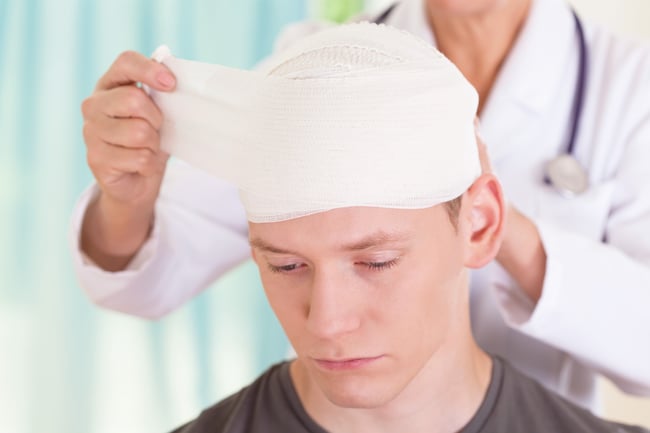 teen with head bandage