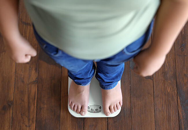 child standing on scale