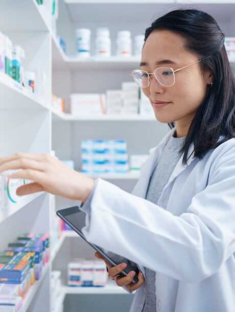 young pharmacist looks at prescriptions