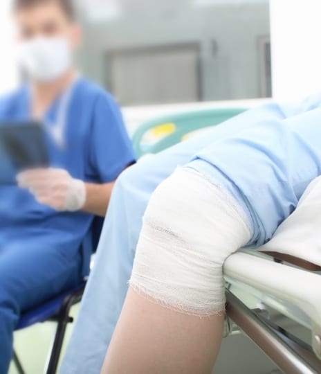 close-up of bandaged knee in emergency room