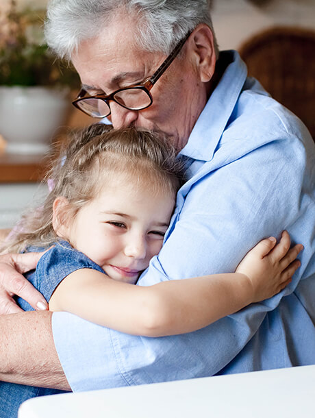 grandparent hugging little girl