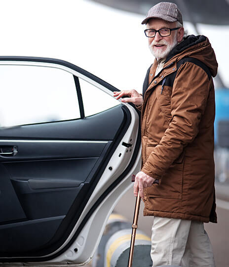 man getting into car