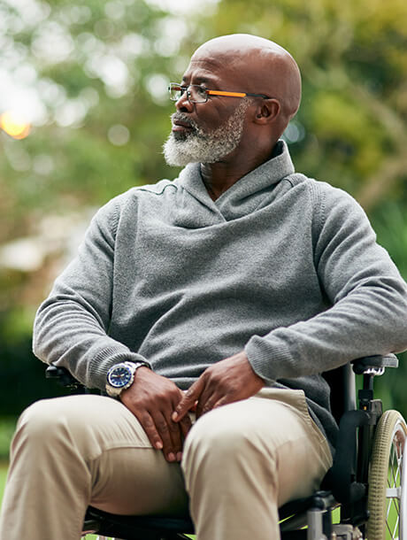 man sitting outside in wheelchair
