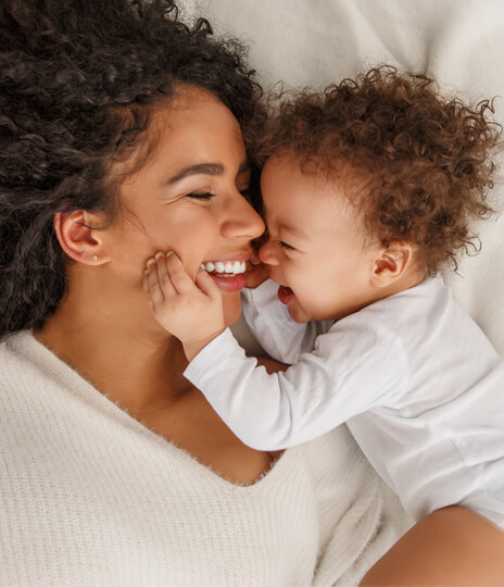 mother snuggling with baby