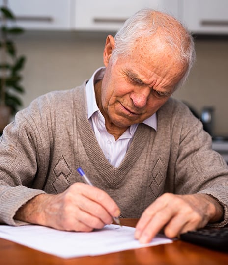 elderly man writing